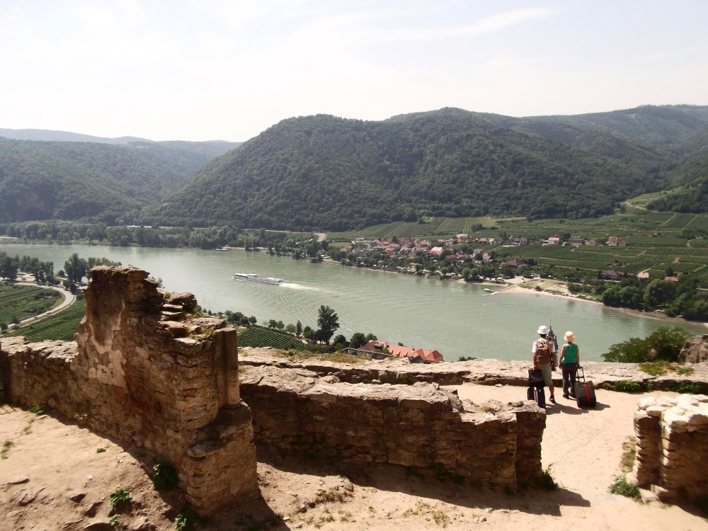 Blick von der Ruine Dürnstein auf die Donau inklusive Touristen mit Trolleykoffer.